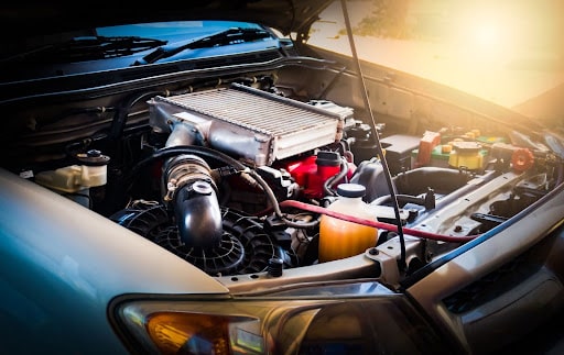 Car Maintenance in Newport, NH at Promex Auto. Image of a car an open hood car for inspection of the cooling panel, engine, oil and electronic system as part of preventive maintenance