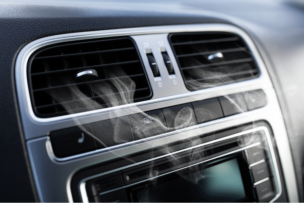 A/C system, auto repair in Newport, NH at Promex Auto. Close-up of a car’s dashboard air vent with visible cold air or mist coming out, indicating active air conditioning.
