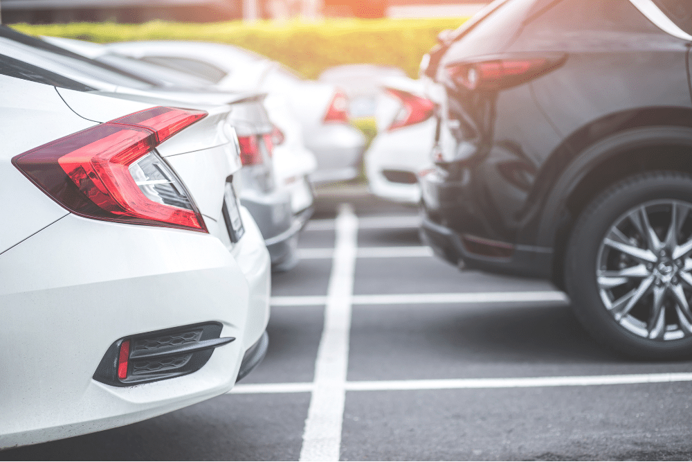 japanese vehicle repair, auto repair in Newport, NH at Promex Auto. Row of parked cars in a lot with clear white lines and compact spacing.