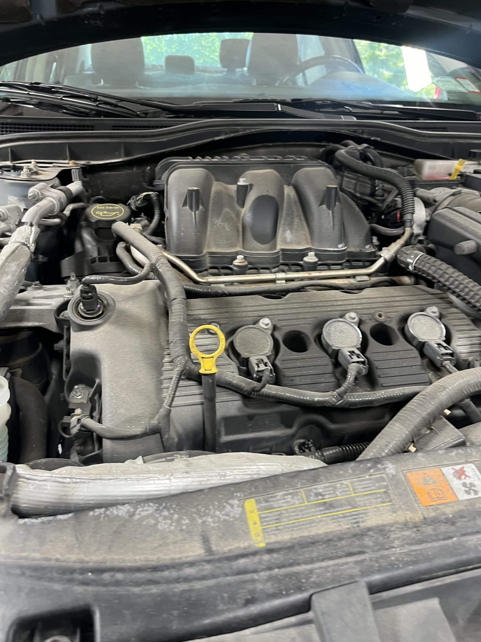 Technician diagnosing engine overheating issue at Promex Auto in Newport, NH
